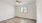 Unfurnished townhome bedroom with hardwood floors and large window at ID Oakland Park