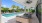 Shaded poolside lounge with ceiling fans in ID Oakland Park's outdoor community area